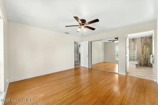 933 Waialae Circle Northeast Palm Bay, FL 32905 - Photo 20 of 32 a view of an empty room and wooden floor