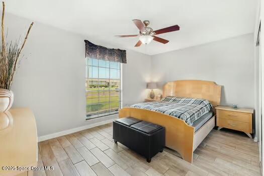 933 Waialae Circle Northeast Palm Bay, FL 32905 - Photo 23 of 32 a bedroom with a bed and window