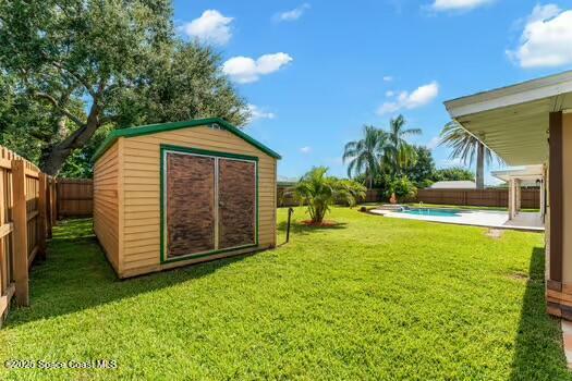 933 Waialae Circle Northeast Palm Bay, FL 32905 - Photo 32 of 32 a front view of a house with a yard