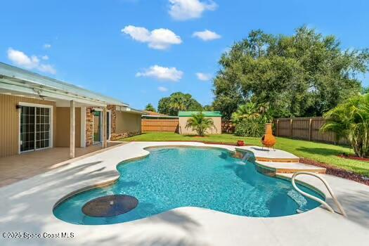 933 Waialae Circle Northeast Palm Bay, FL 32905 - Photo 6 of 32 a view of a house with swimming pool and a yard