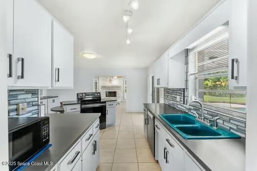 933 Waialae Circle Northeast Palm Bay, FL 32905 - Photo 8 of 32 a kitchen with kitchen island granite countertop a sink a counter top space appliances and cabinets