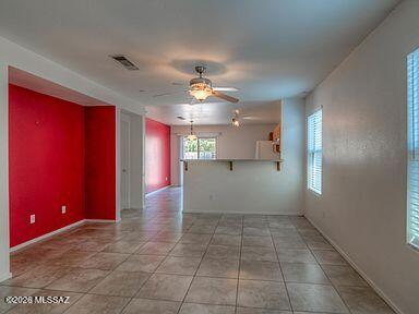 3248 West Treece Place Tucson, AZ 85742 - Photo 7 of 17 a view of a hallway with a chandelier fan and windows