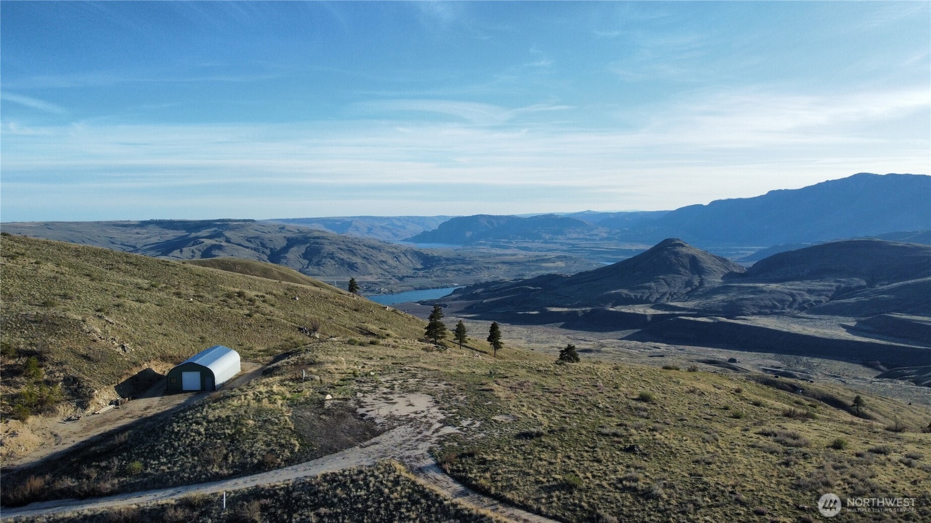 180 Harmony Heights Road Brewster, WA 98812 - Photo 2 of 13 a view of a backyard with wooden fence