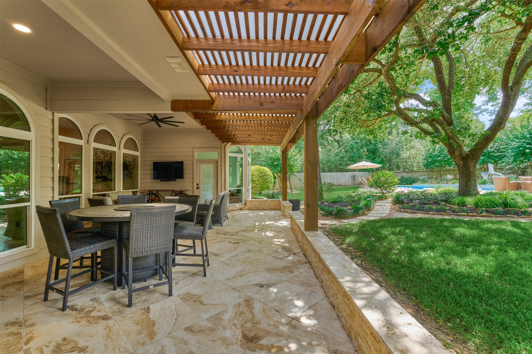 18 Treevine Court The Woodlands, TX 77381 - Photo 41 of 50 Picturesque covered veranda is expansive, offering truly sublime views of the park-like backyard setting.