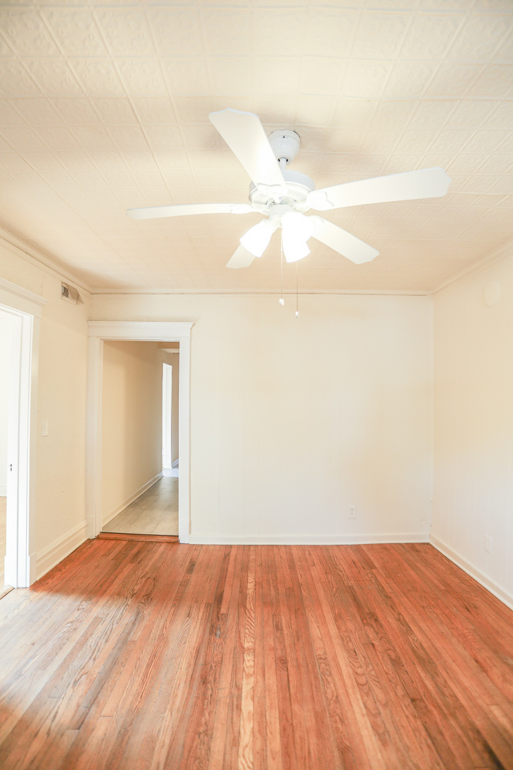 2315 West School Street, Unit G Chicago, IL 60618 - Photo 3 of 12 a view of empty room with wooden floor