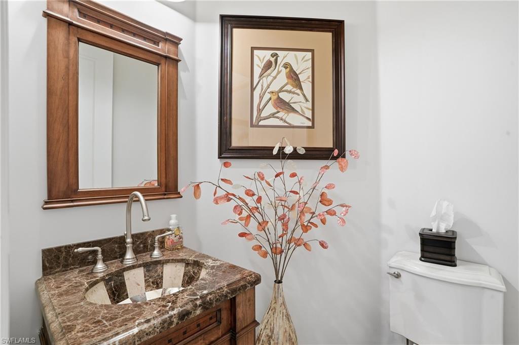 430 Saddlebrook Lane Naples, FL 34110 - Photo 13 of 37 a bathroom with a sink and a mirror