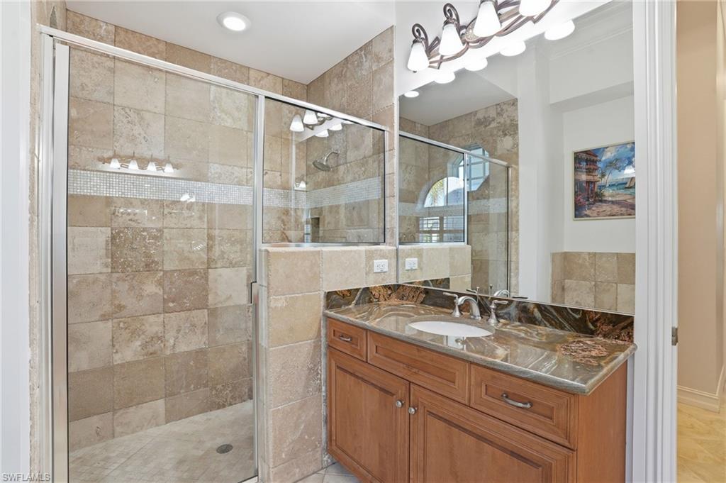 430 Saddlebrook Lane Naples, FL 34110 - Photo 16 of 37 a bathroom with a sink vanity granite and shower