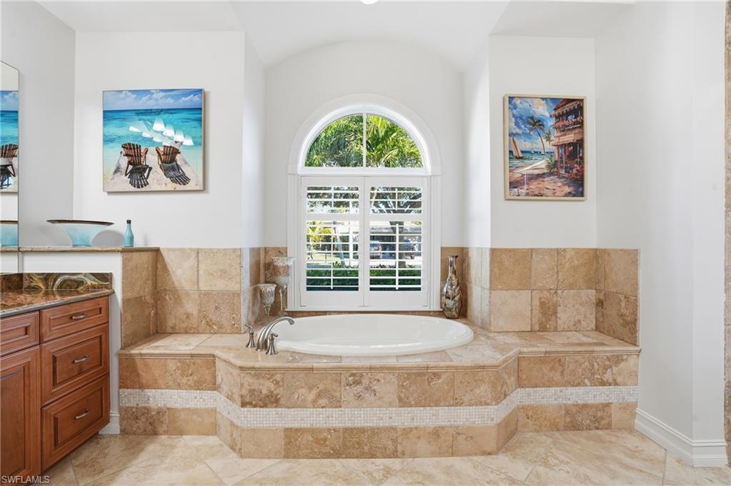 430 Saddlebrook Lane Naples, FL 34110 - Photo 18 of 37 a spacious bathroom with a tub and window