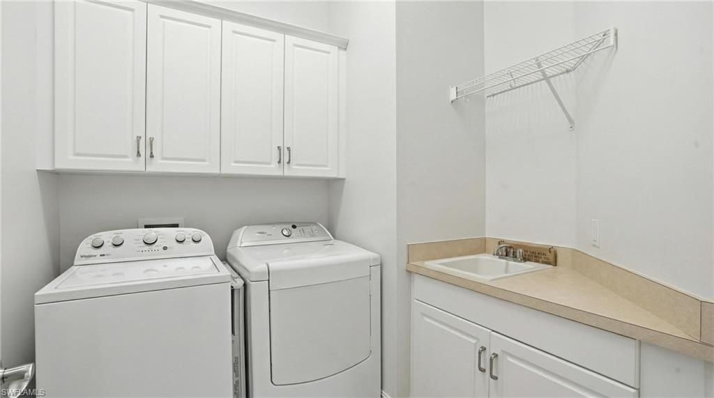 430 Saddlebrook Lane Naples, FL 34110 - Photo 23 of 37 a utility room with dryer and washer