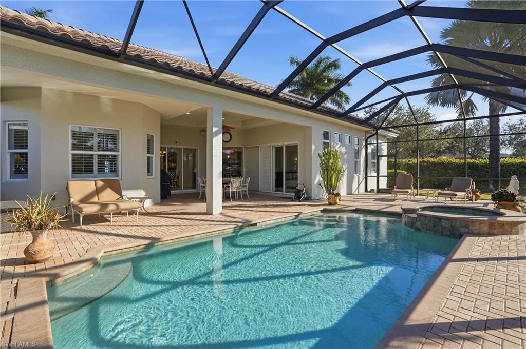 430 Saddlebrook Lane Naples, FL 34110 - Photo 29 of 37 a view of a swimming pool with outdoor seating