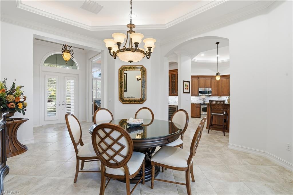430 Saddlebrook Lane Naples, FL 34110 - Photo 4 of 37 a view of a dining room with furniture a chandelier and wooden floor