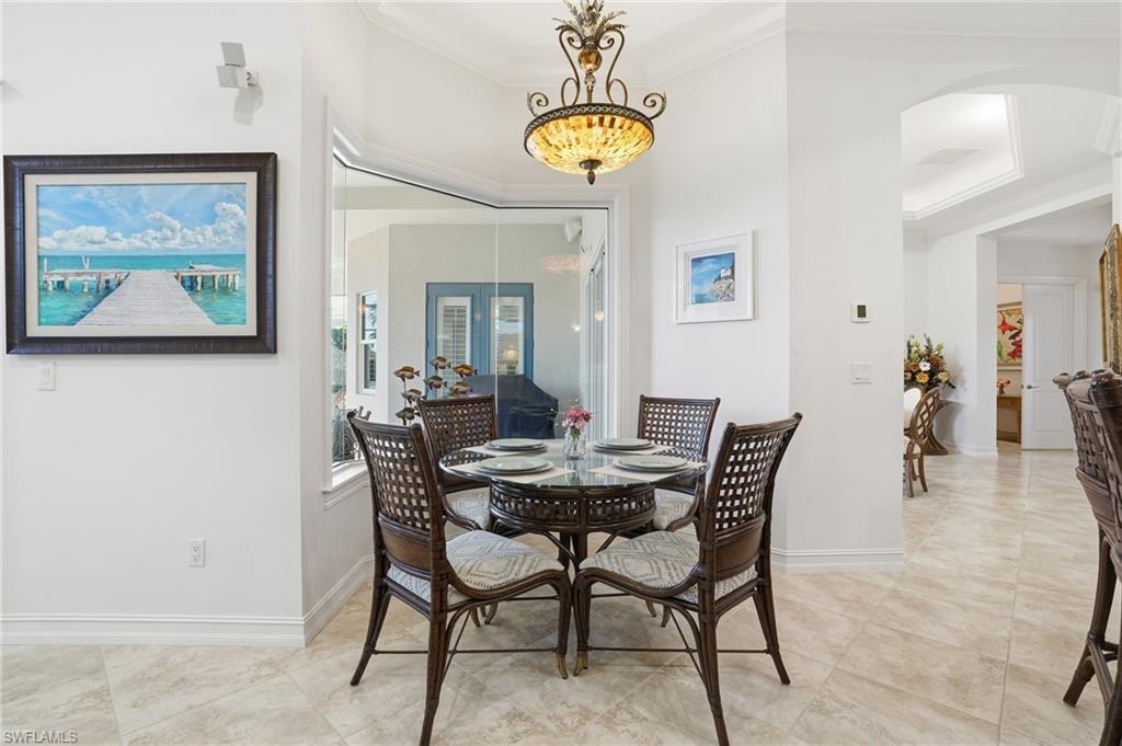 430 Saddlebrook Lane Naples, FL 34110 - Photo 10 of 37 a view of a dining room with furniture and chandelier