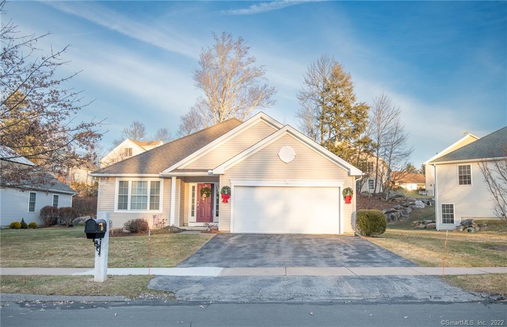 a view of a white house with a yard and plants