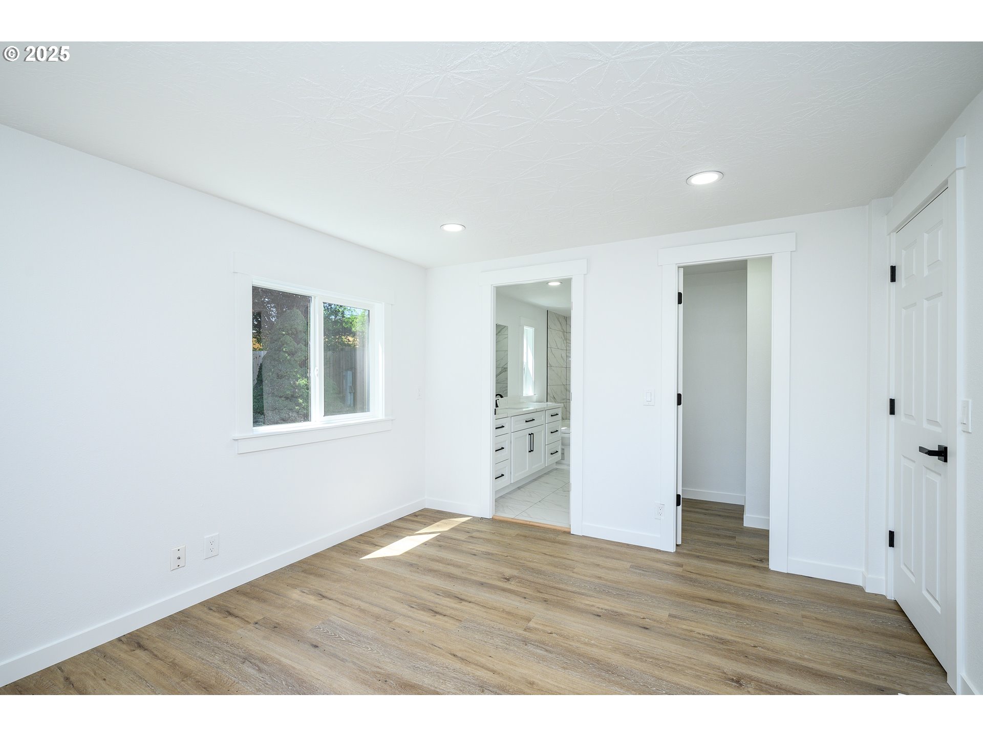 13620 Southwest Beef Bend Road, Unit 38 Portland, OR 97224 - Photo 11 of 38 a view of an empty room with wooden floor and a window