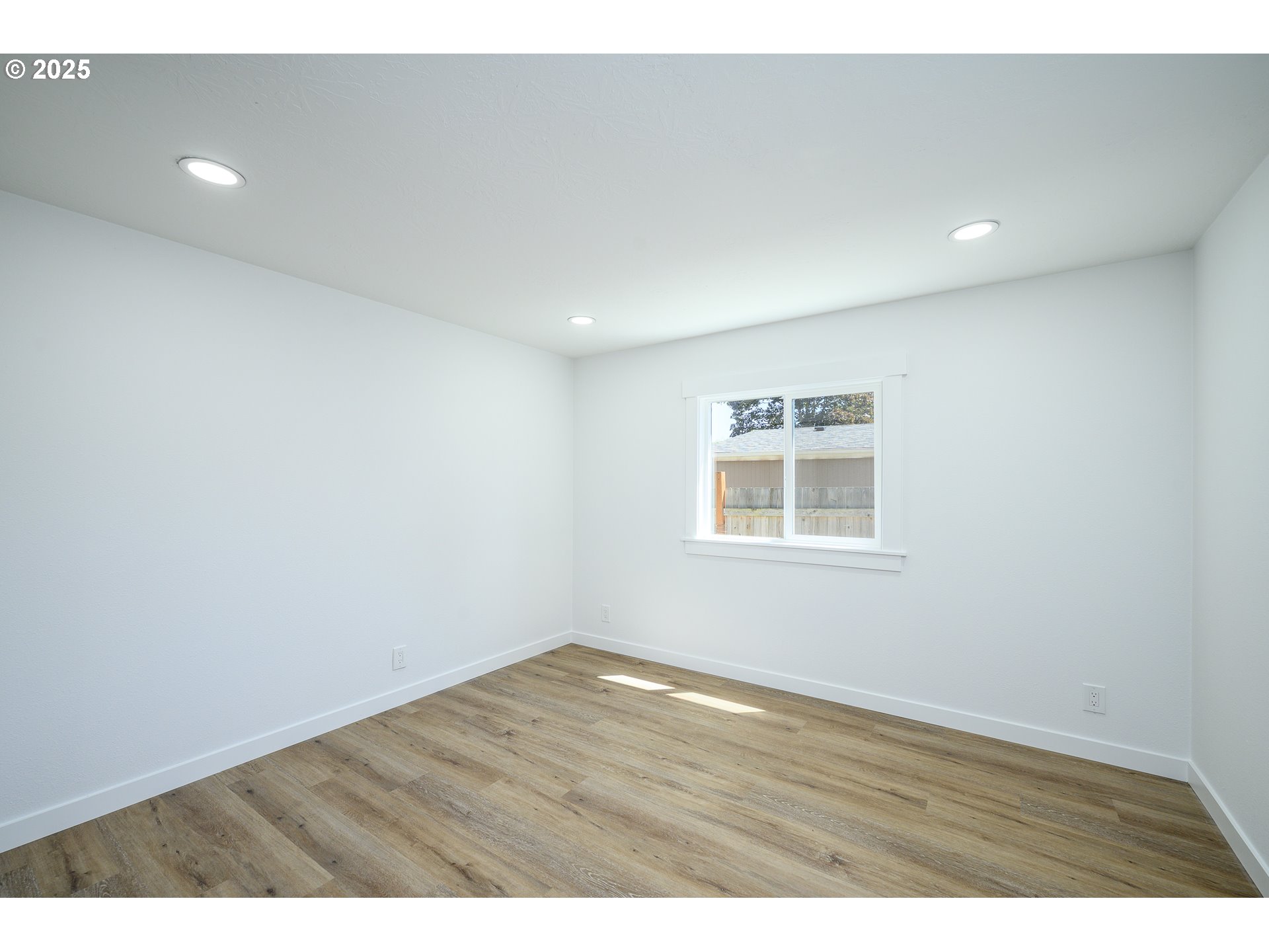 13620 Southwest Beef Bend Road, Unit 38 Portland, OR 97224 - Photo 16 of 38 a view of an empty room with wooden floor and a window