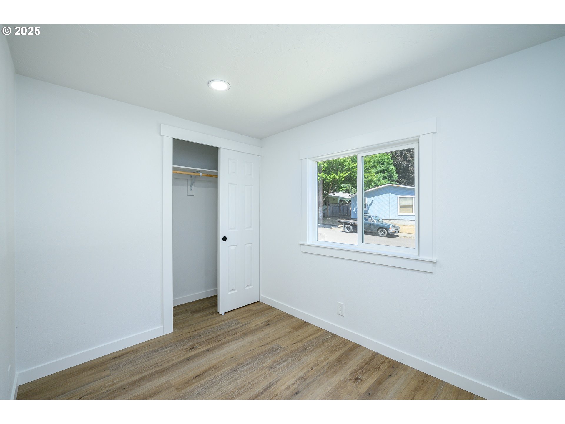 13620 Southwest Beef Bend Road, Unit 38 Portland, OR 97224 - Photo 18 of 38 a view of an empty room with wooden floor and a window