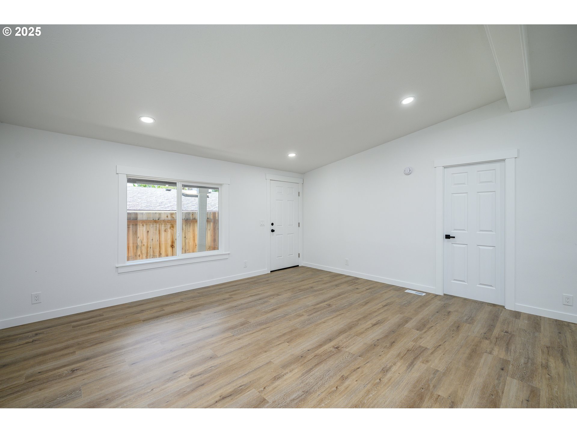 13620 Southwest Beef Bend Road, Unit 38 Portland, OR 97224 - Photo 4 of 38 a view of an empty room with wooden floor and a window