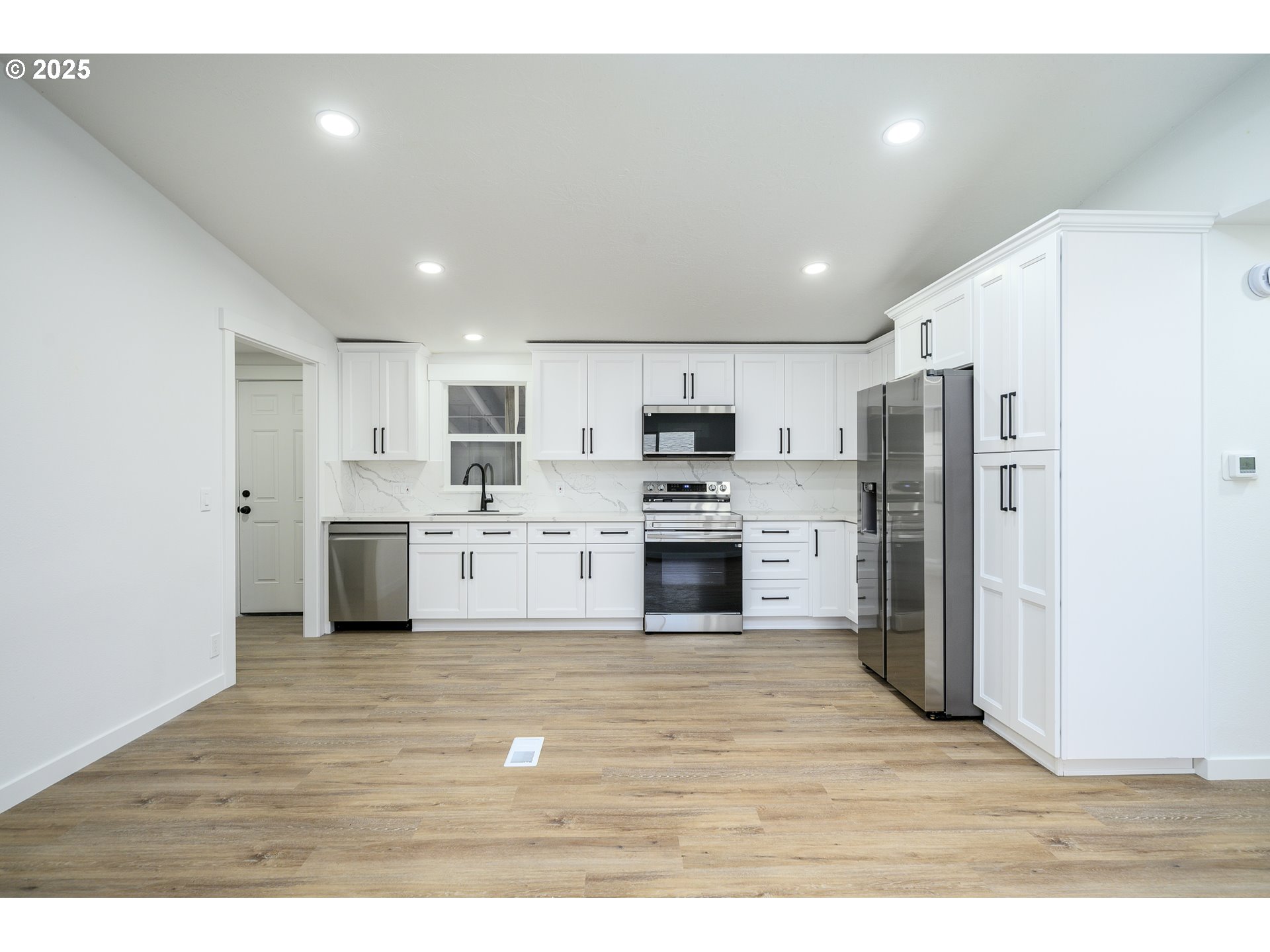 13620 Southwest Beef Bend Road, Unit 38 Portland, OR 97224 - Photo 5 of 38 a large kitchen with cabinets and stainless steel appliances