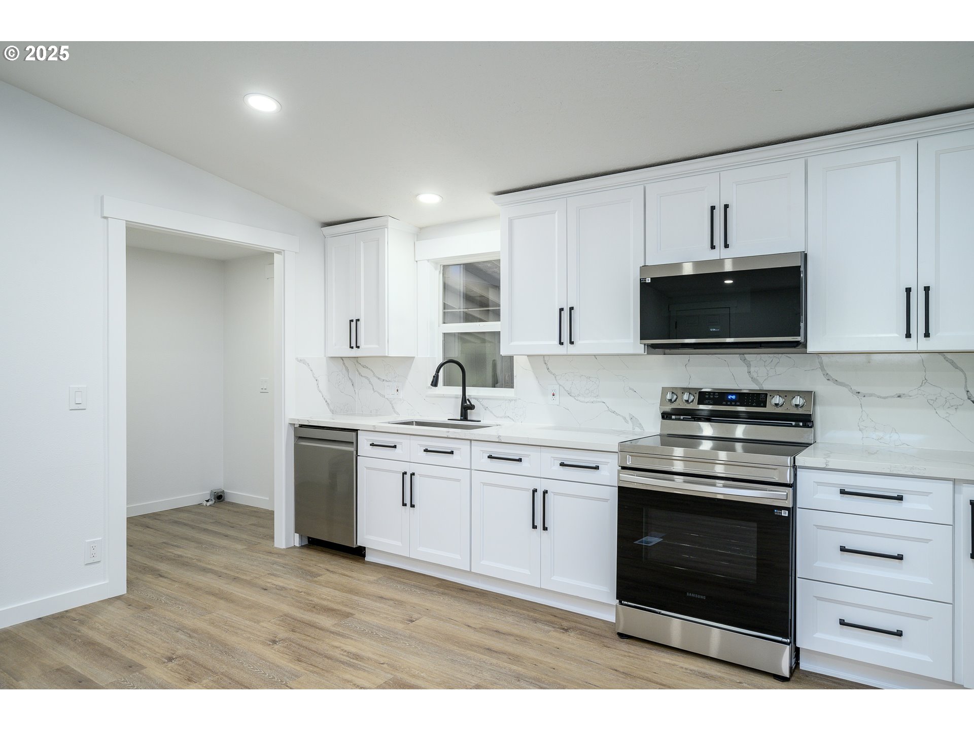 13620 Southwest Beef Bend Road, Unit 38 Portland, OR 97224 - Photo 7 of 38 a kitchen with stainless steel appliances granite countertop a stove a sink and a microwave