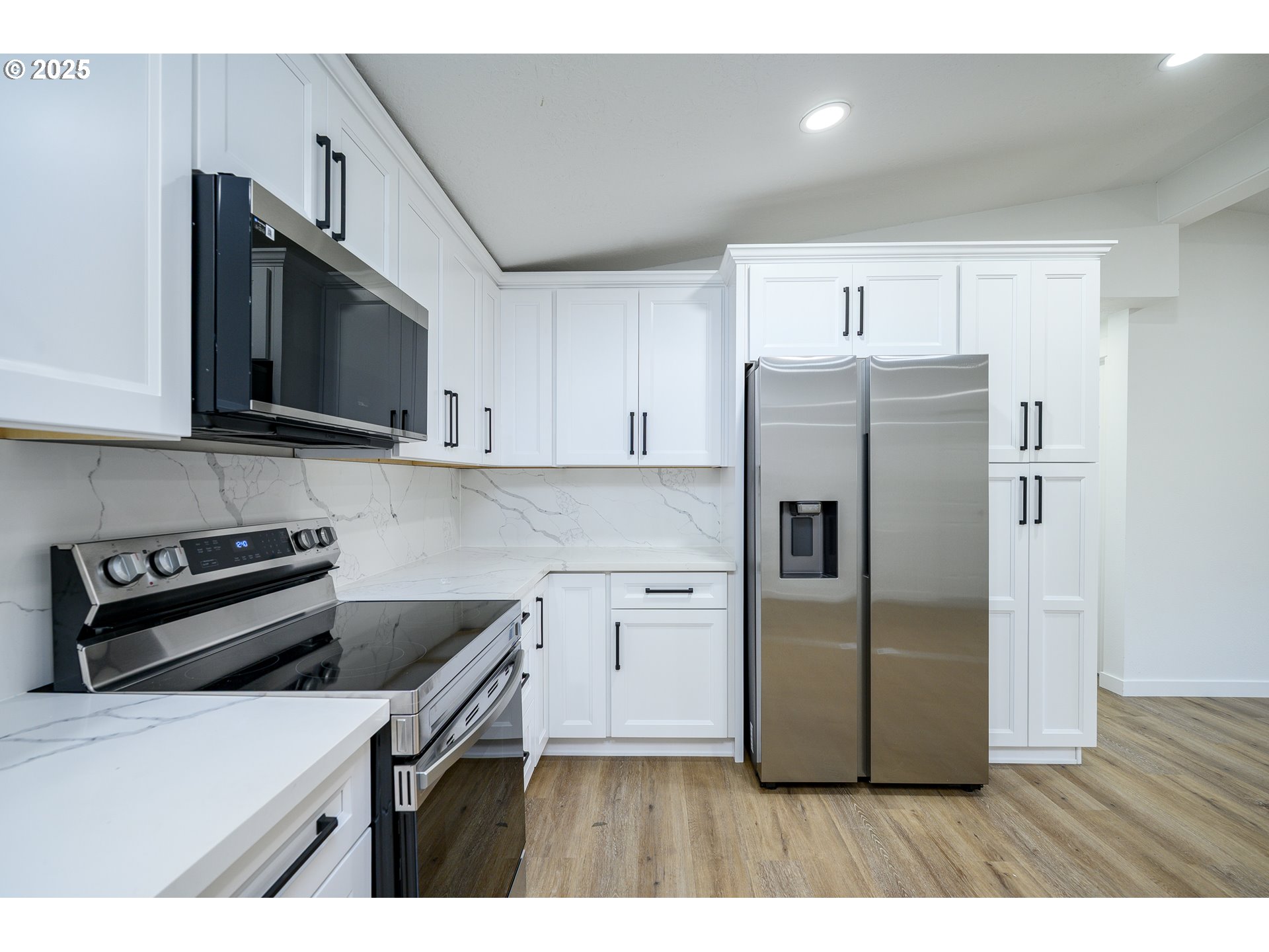 13620 Southwest Beef Bend Road, Unit 38 Portland, OR 97224 - Photo 9 of 38 a kitchen with stainless steel appliances a refrigerator a stove a microwave and wooden cabinets