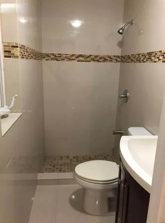 a bathroom with a toilet a sink and a shower