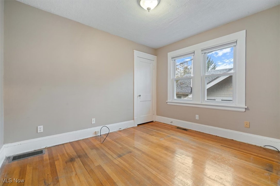 4488 Rainbow Road Cleveland, OH 44121 - Photo 21 of 39 Empty room featuring a textured ceiling and light hardwood / wood-style flooring
