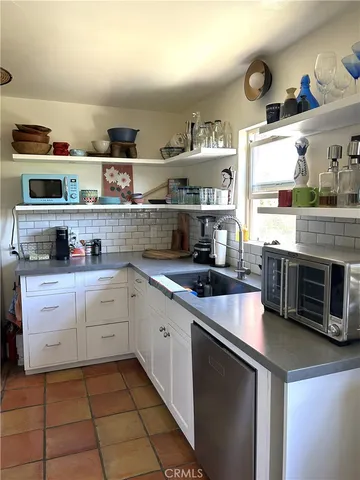 a kitchen with stainless steel appliances a refrigerator and a sink