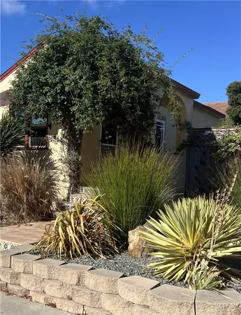 a view of a backyard with furniture and a grill