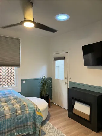 a bedroom with a bed couch and window