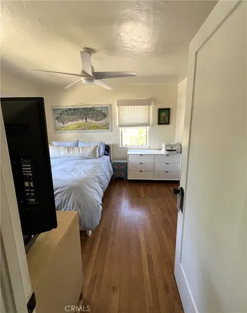 a bedroom with furniture and a flat screen tv