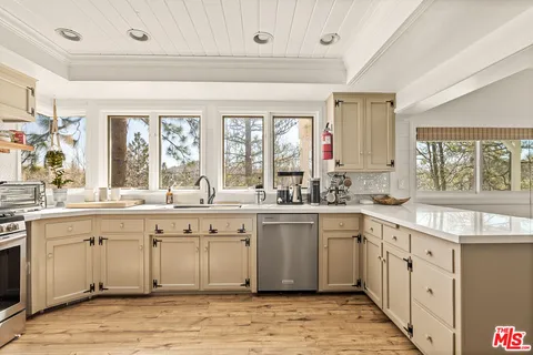 a room with a refrigerator and a sink