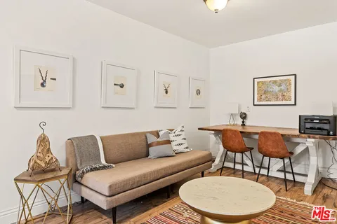 a view of a hallway with entryway wooden floor and front door