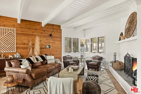 a living room with furniture and a floor to ceiling window