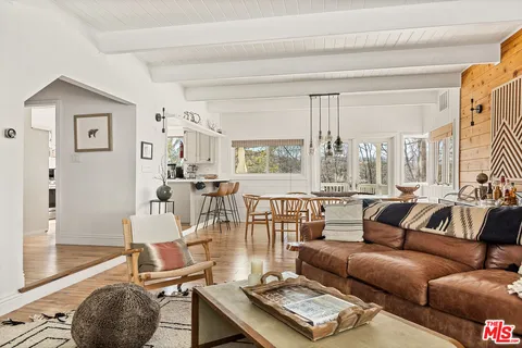 a living room with dining table and chairs