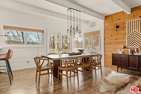 a kitchen with a sink cabinets and wooden floor