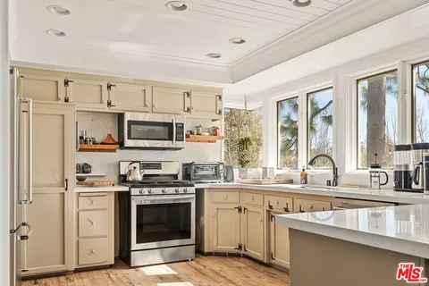 a large white kitchen with a window