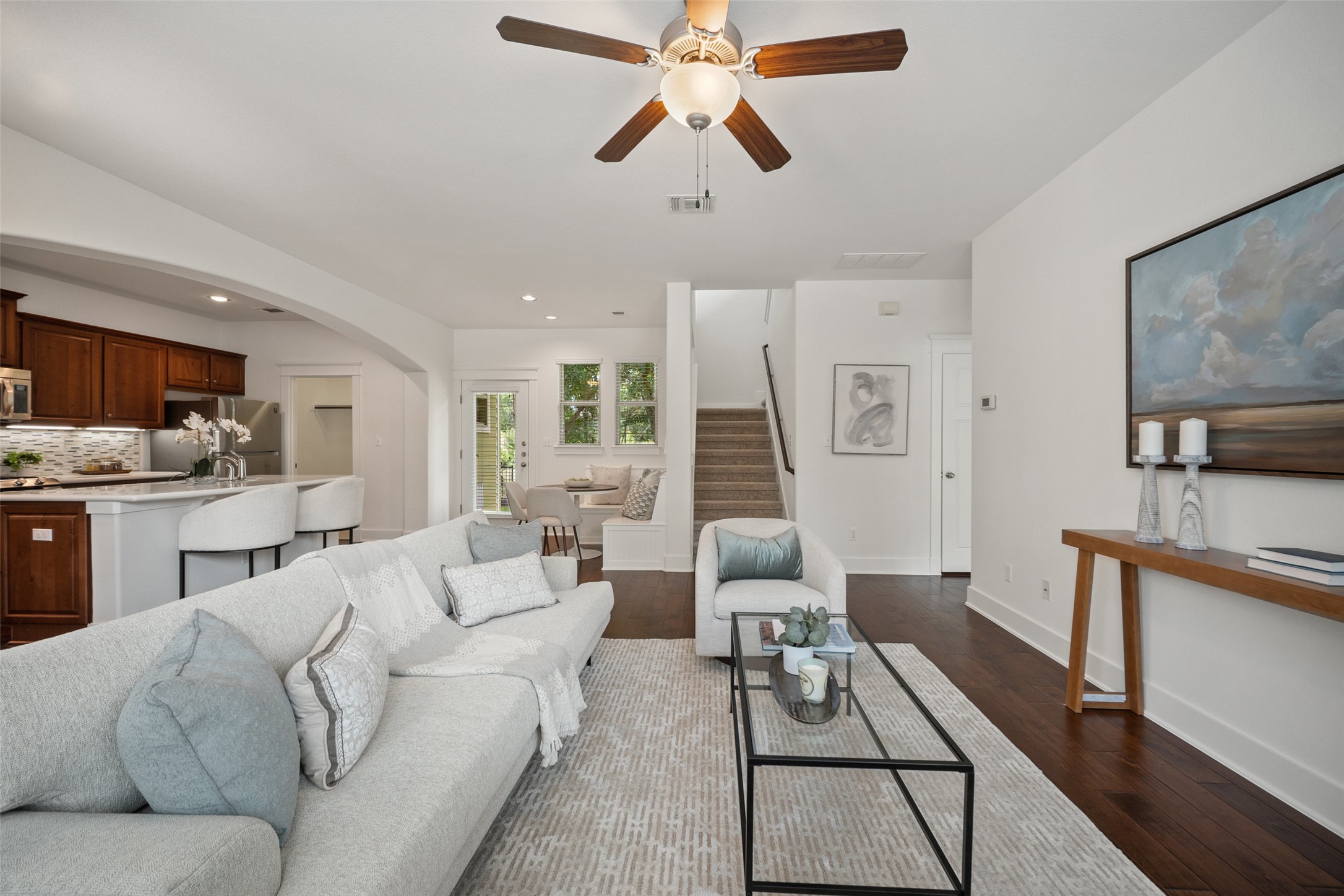 11013 Avery Station Loop, Unit 31 Austin, TX 78717 - Photo 12 of 38 Whether you're curled up with a book or hosting a lively dinner, the living room's relaxed atmosphere and connection to the greenbelt ensure every moment spent here feels peaceful and welcoming