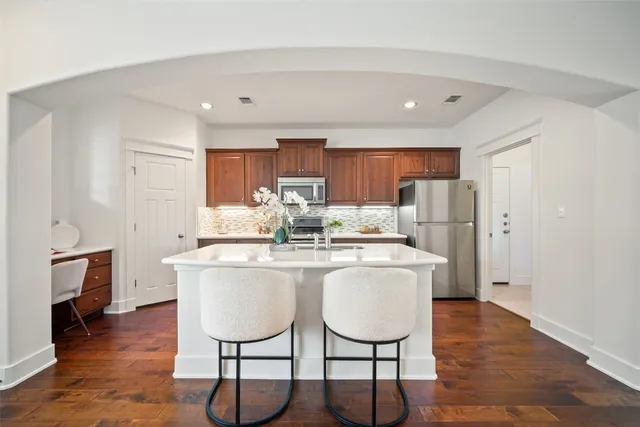a kitchen with stainless steel appliances granite countertop a sink stove and cabinets