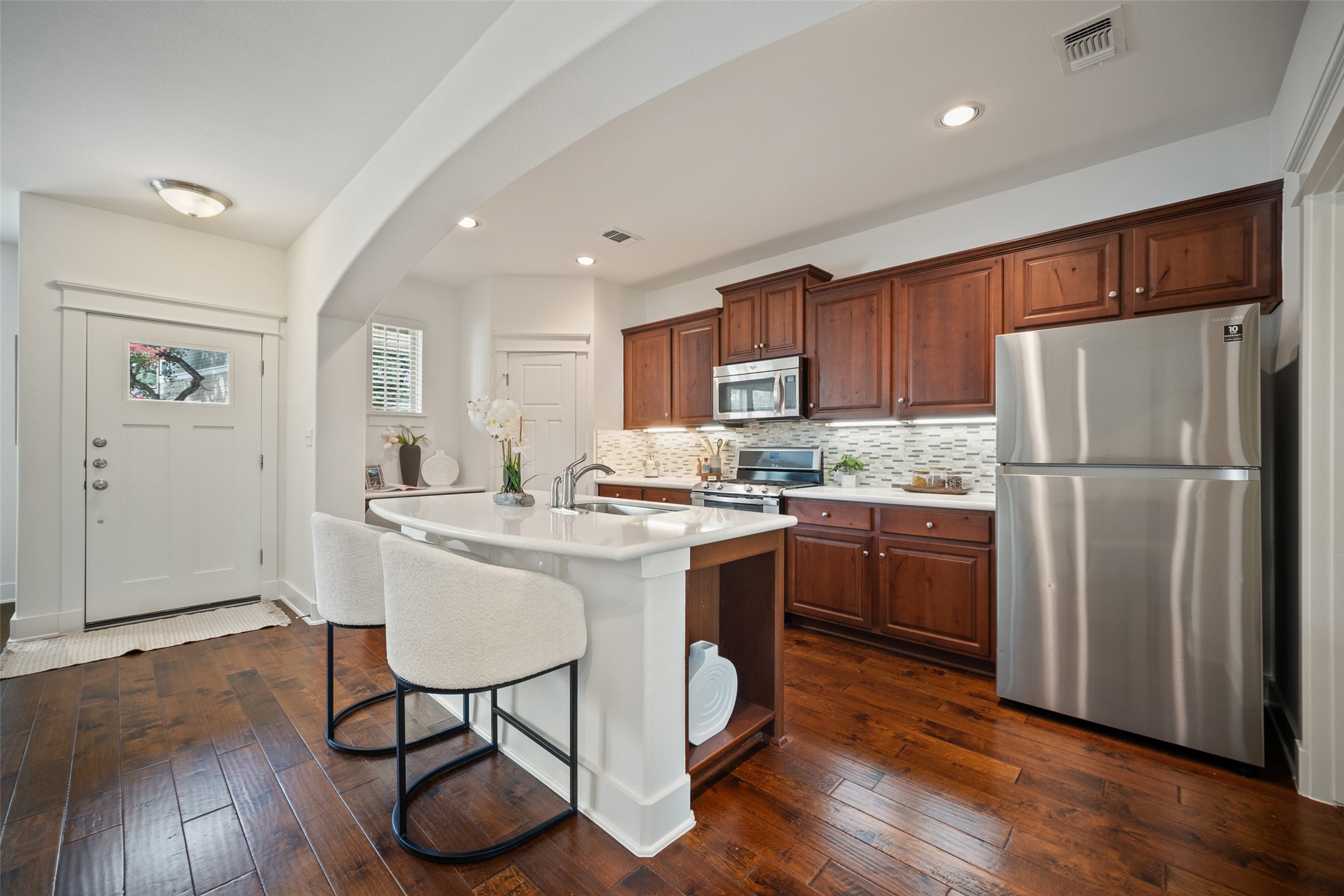 11013 Avery Station Loop, Unit 31 Austin, TX 78717 - Photo 15 of 38 With stainless steel appliances, wood cabinetry, tile backsplash and a built-in breakfast bar in the center island, it’s ideal for everything from morning coffee to Sunday brunch