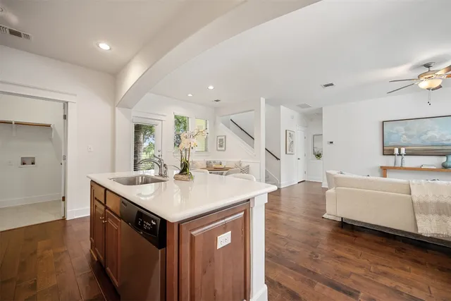a bathroom with a granite countertop sink a mirror and shower