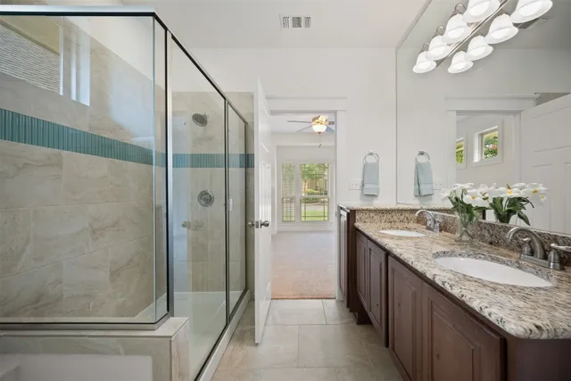 a bathroom with a sink a tub and a mirror