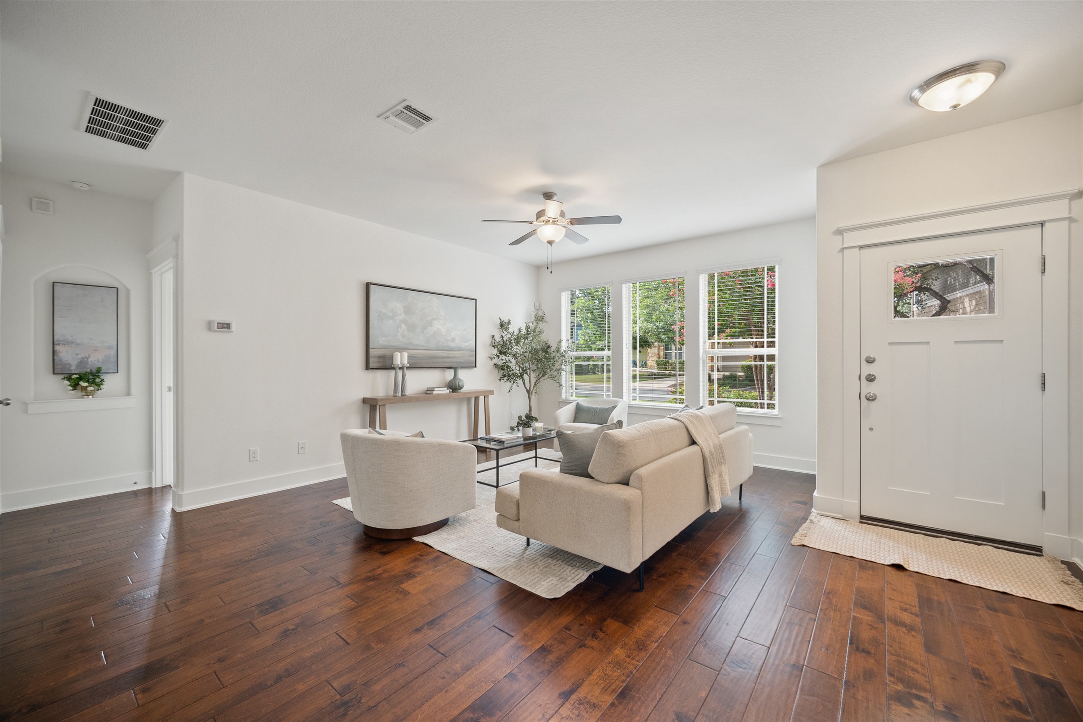 11013 Avery Station Loop, Unit 31 Austin, TX 78717 - Photo 8 of 38 The living room, with its expansive wall of windows, floods the space with natural light and offers an unobstructed view of the greenbelt, making it feel like the outdoors is right there with you