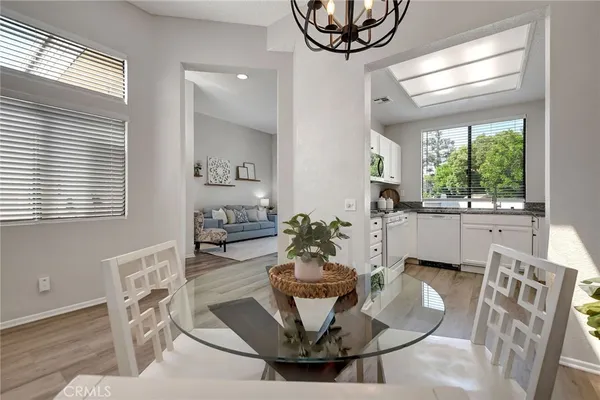 a kitchen with granite countertop a sink cabinets stainless steel appliances and a window