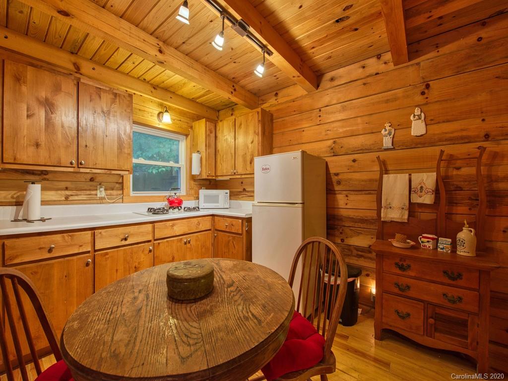 784 Flat Branch Road Waynesville, NC 28785 - Photo 11 of 25 a kitchen with refrigerator and window