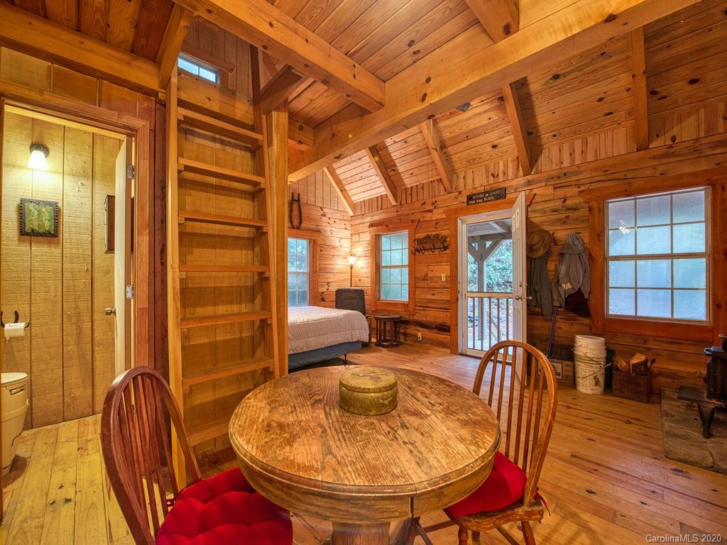 784 Flat Branch Road Waynesville, NC 28785 - Photo 12 of 25 a view of a balcony with table and chairs