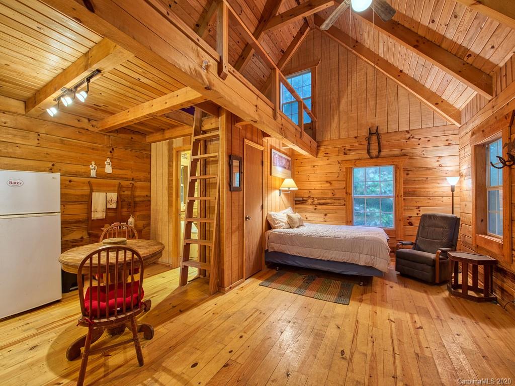 784 Flat Branch Road Waynesville, NC 28785 - Photo 13 of 25 a bedroom with furniture and wooden floors