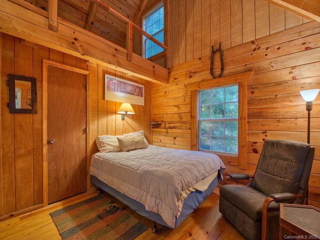 784 Flat Branch Road Waynesville, NC 28785 - Photo 16 of 25 a bedroom with a bed and a couch