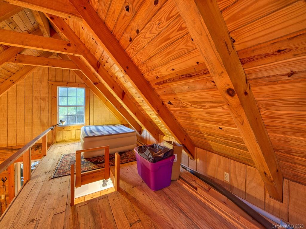 784 Flat Branch Road Waynesville, NC 28785 - Photo 18 of 25 a balcony with chairs and wooden floor