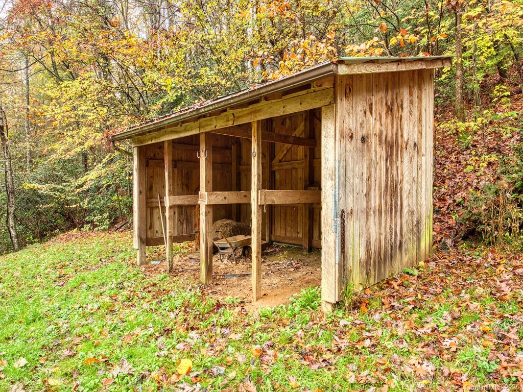 784 Flat Branch Road Waynesville, NC 28785 - Photo 24 of 25 a backyard of a house with table and chairs