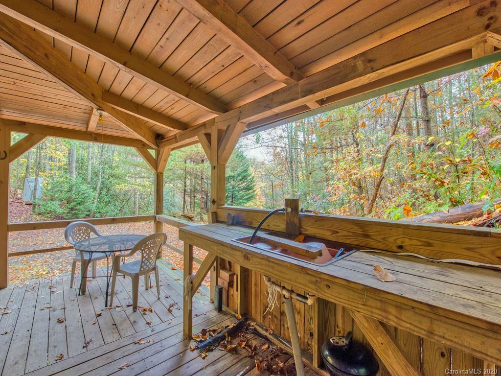 784 Flat Branch Road Waynesville, NC 28785 - Photo 4 of 25 a view of a two chairs in the balcony